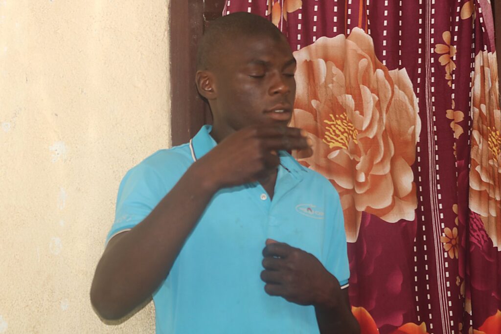 A man signing in Liberian sign language during a community session.